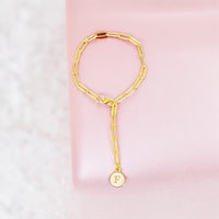 a gold plated ring with a letter engraved on it