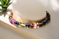 a multi colored beaded necklace on a mannequin