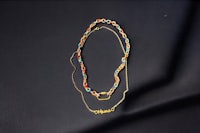 a gold plated necklace with a name written on it